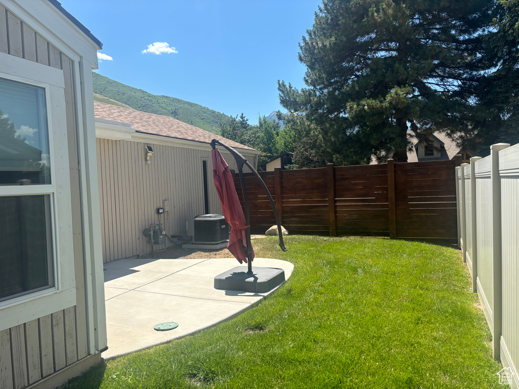 Fenced backyard with a mountain view and a patio