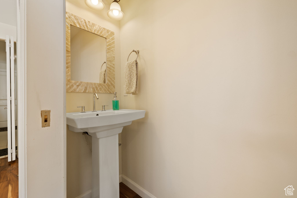 Bathroom with baseboards and wood finished floors