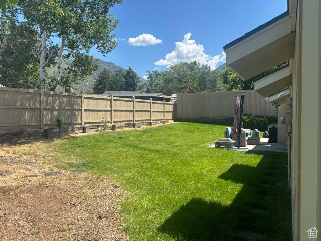 Fenced backyard with a mountain view