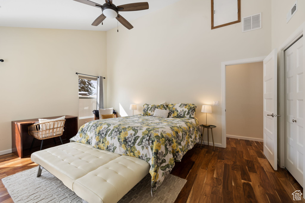 Bedroom featuring high vaulted ceiling, wood finished floors, and ceiling fan