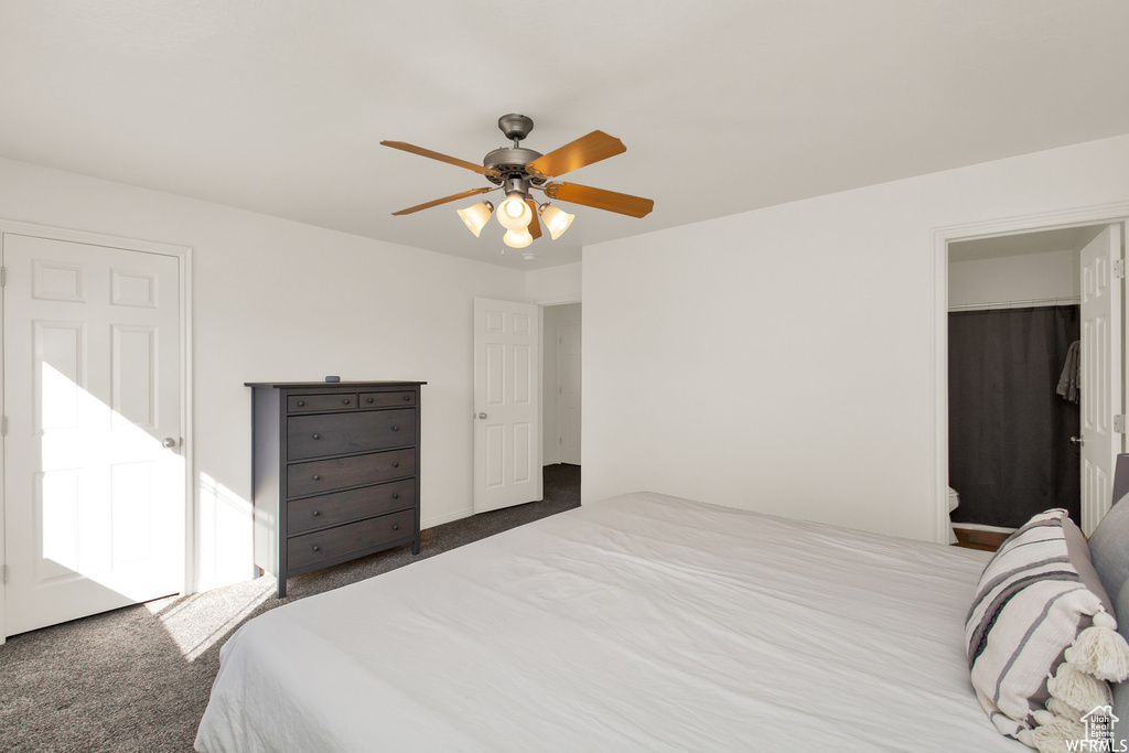 Carpeted bedroom featuring a ceiling fan