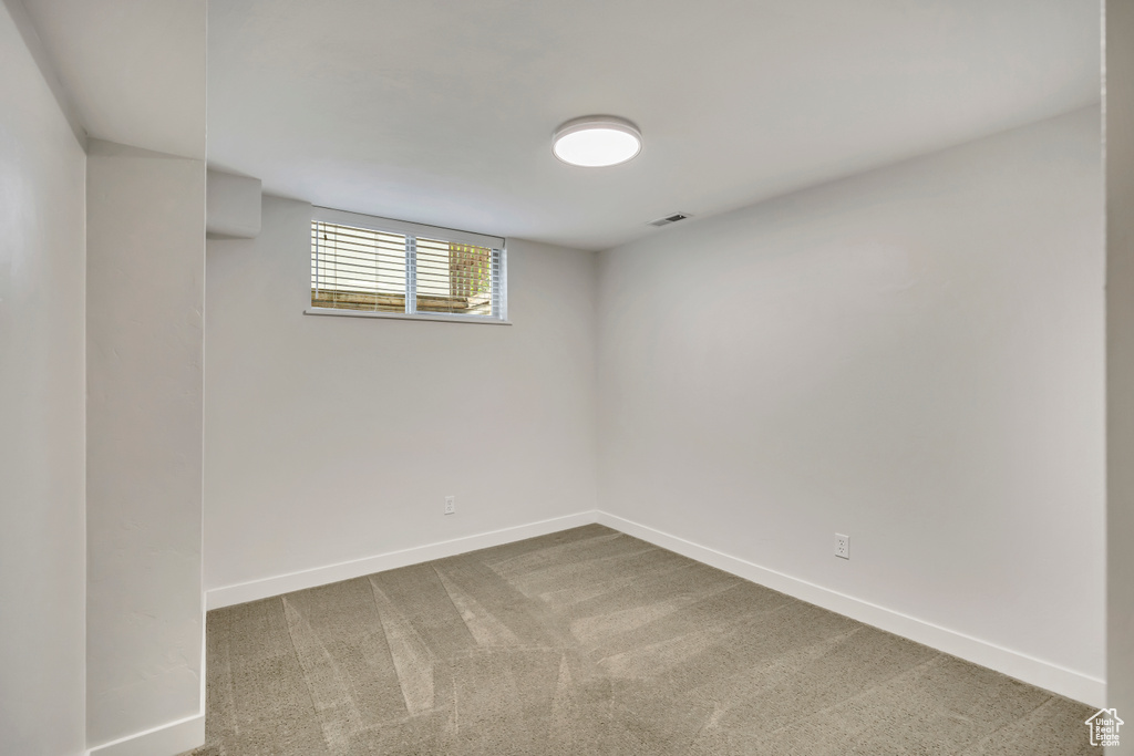 Basement with baseboards and carpet floors