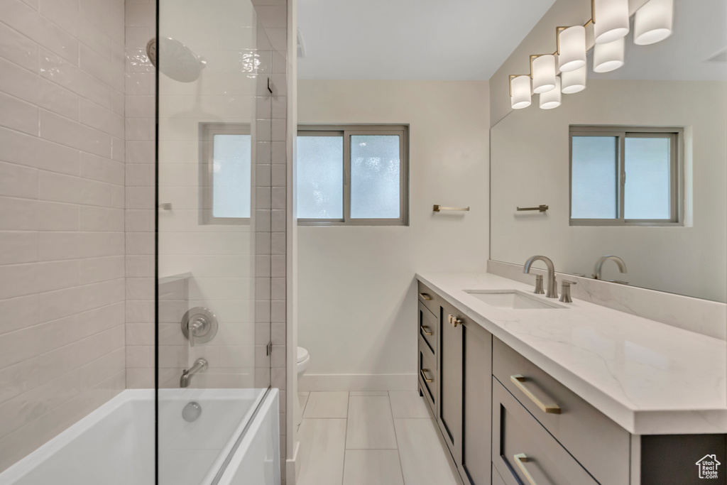 Full bathroom with vanity, tile patterned floors, and tub / shower combination