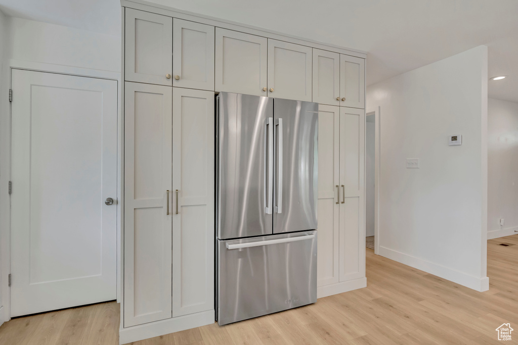 Kitchen featuring freestanding refrigerator, light wood finished floors, and recessed lighting