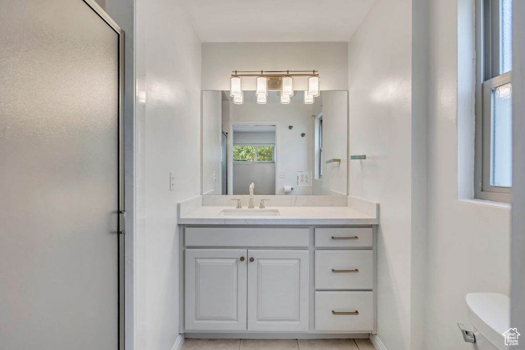 Bathroom featuring vanity and an enclosed shower