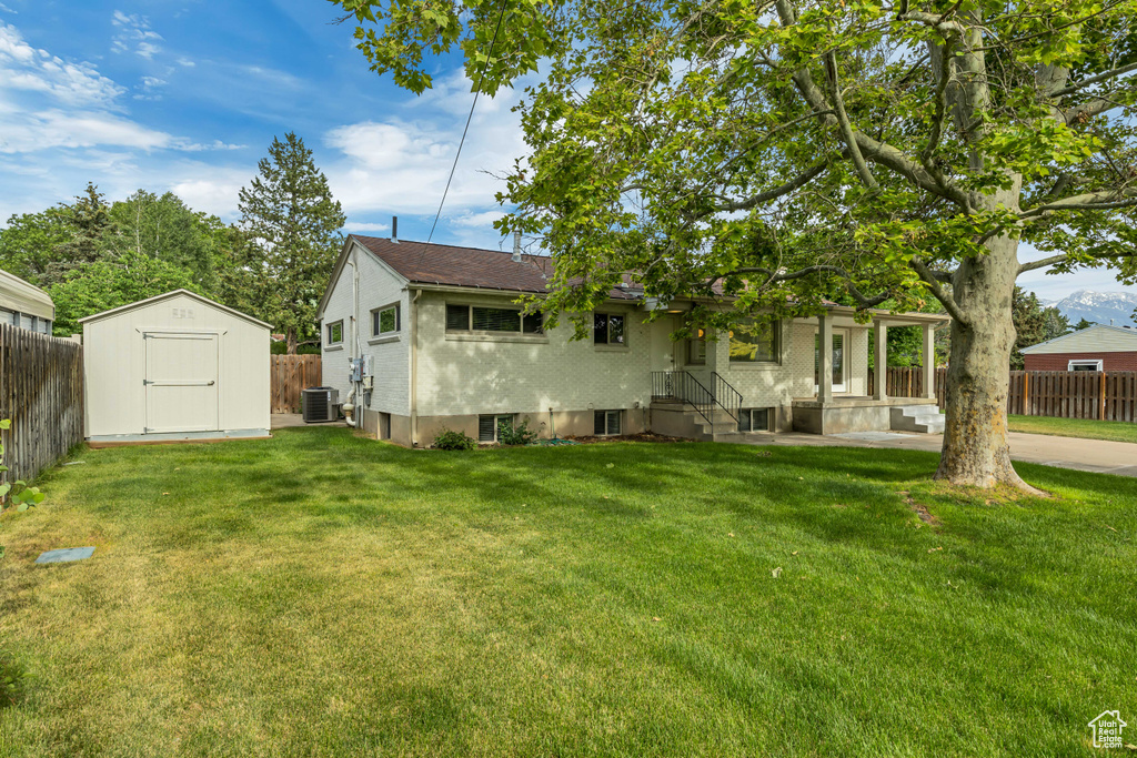 Rear view of house with a storage unit