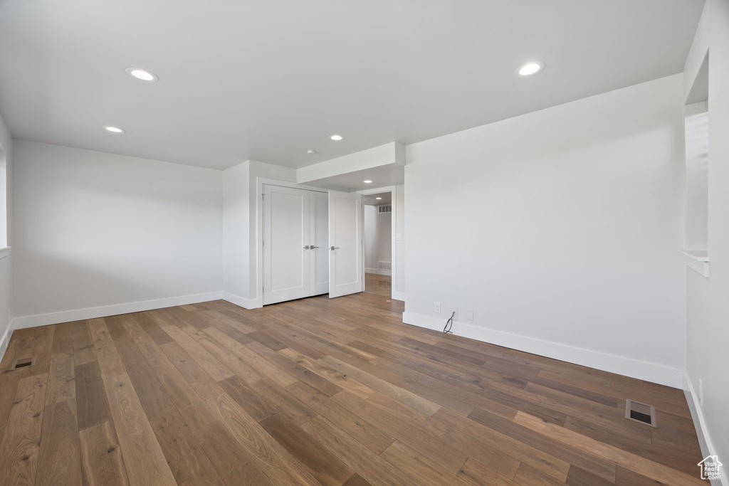 Spare room with wood finished floors and recessed lighting