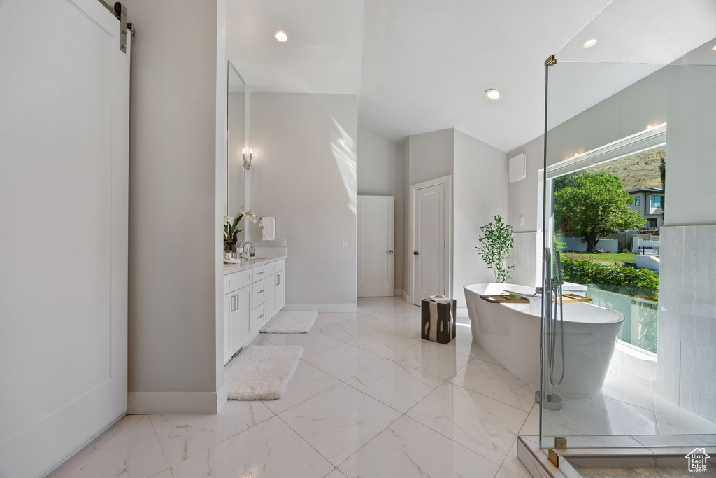 Full bathroom with vanity, a freestanding tub, marble finish flooring, recessed lighting, and a shower with shower door