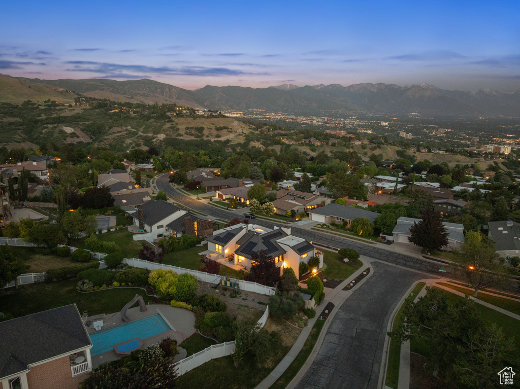 Aerial view of property's location featuring a mountainous background and a pool area