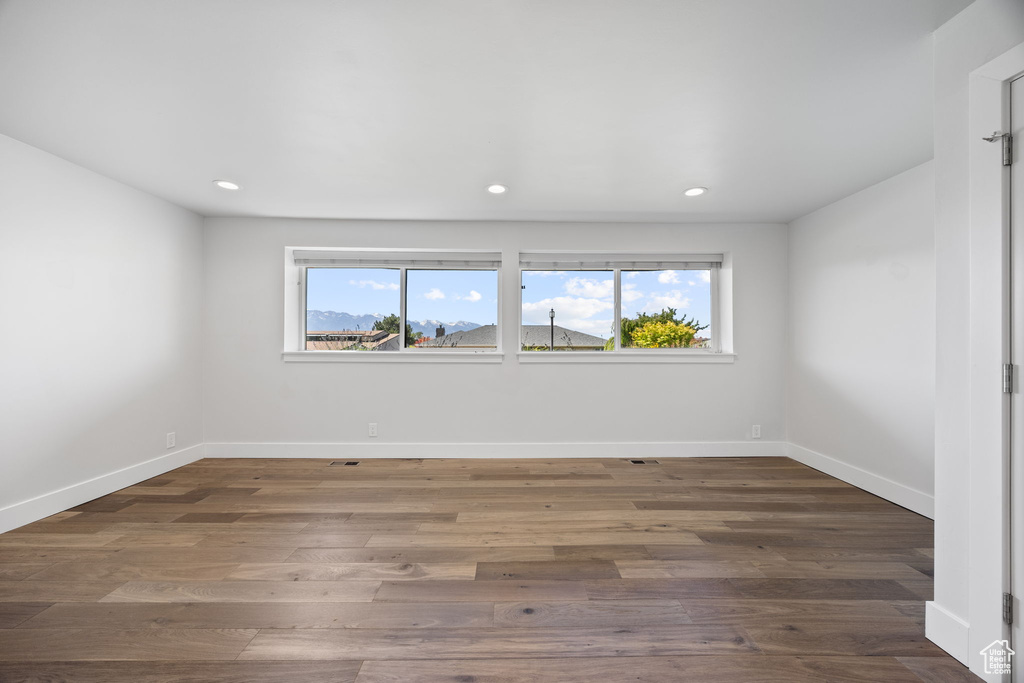 Unfurnished room with recessed lighting and wood finished floors