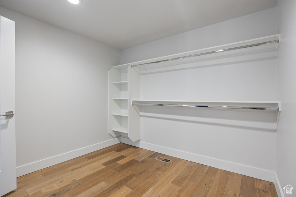 Spacious closet with light wood-style floors