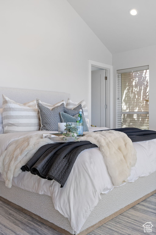Bedroom featuring lofted ceiling and recessed lighting