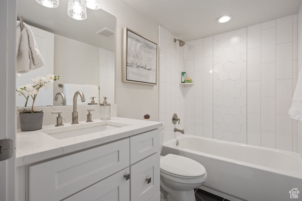 Bathroom with vanity, shower / washtub combination, and recessed lighting