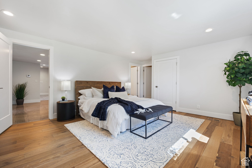 Bedroom with light wood-style flooring and recessed lighting