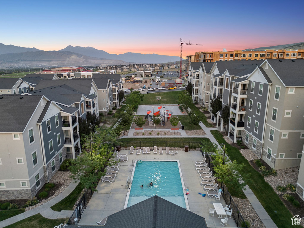 Aerial view at dusk of view of pool and a mountain view