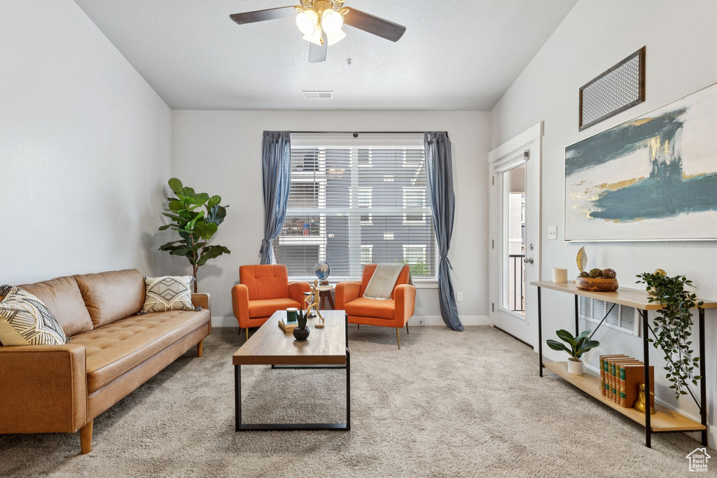 Living area with carpet flooring and ceiling fan