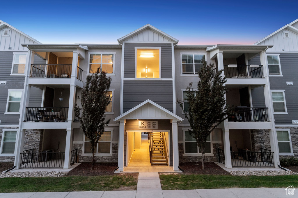 Townhome / multi-family property with board and batten siding and stone siding