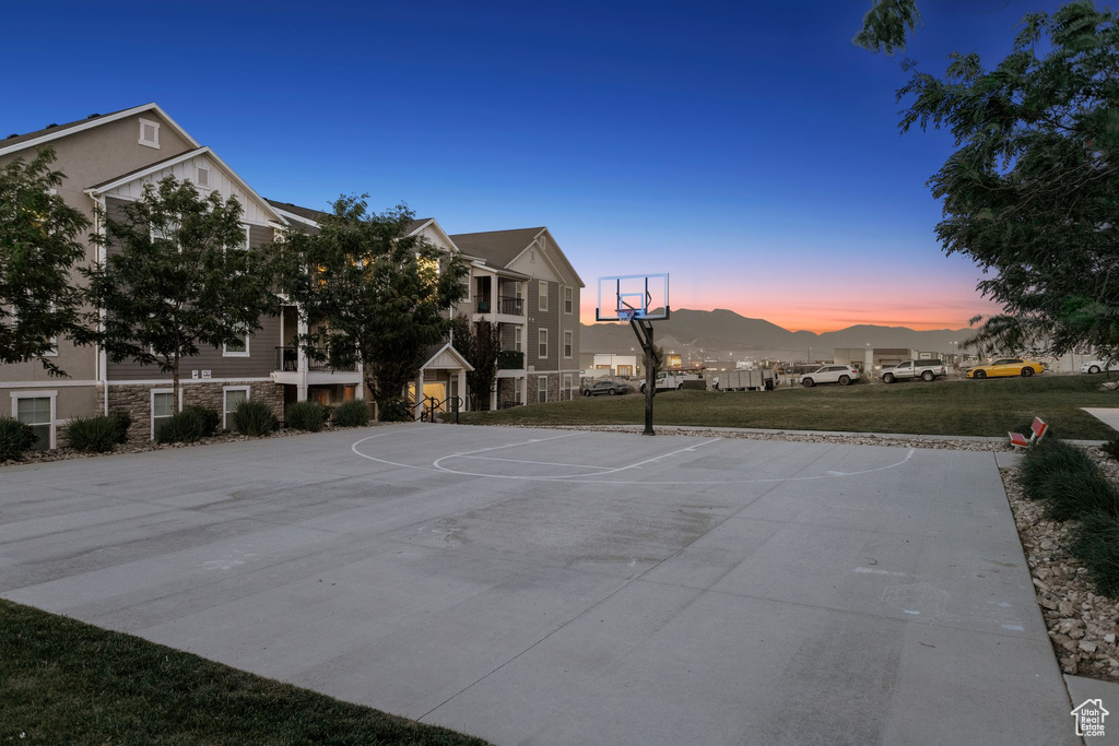View of sport court featuring community basketball court and a lawn