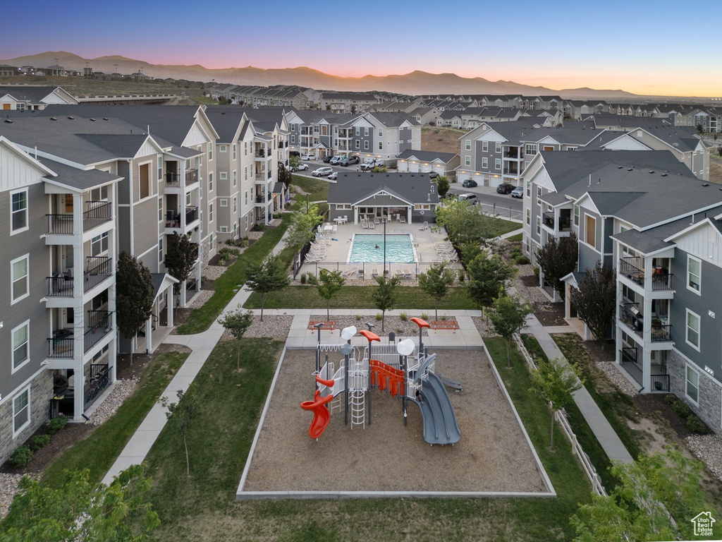 Aerial view at dusk of view of pool, a residential view, and a mountain view