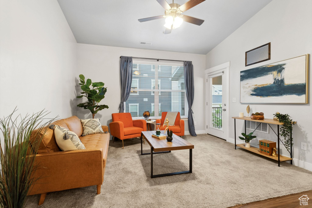 Living area featuring ceiling fan and vaulted ceiling