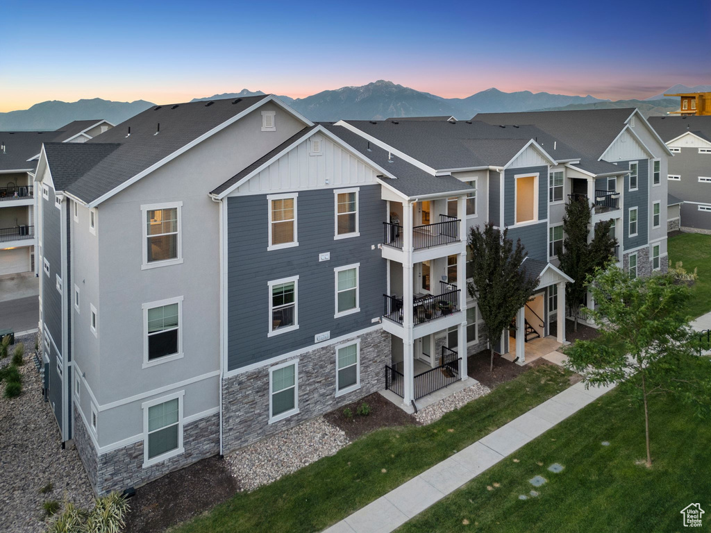 Property at dusk with a mountain view