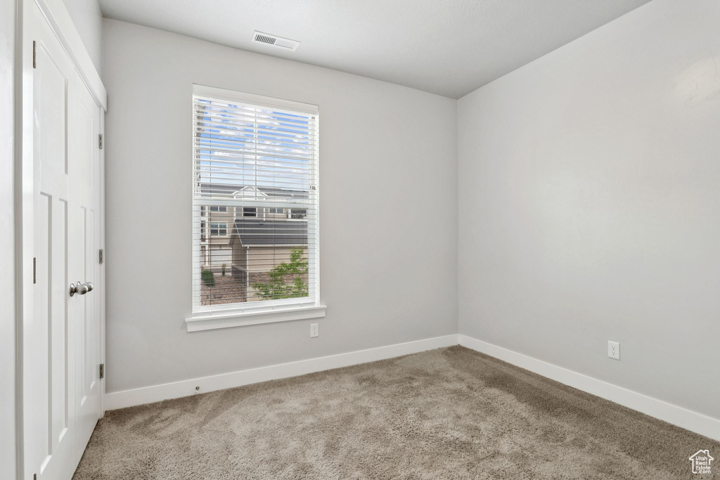 Unfurnished bedroom with baseboards and carpet floors