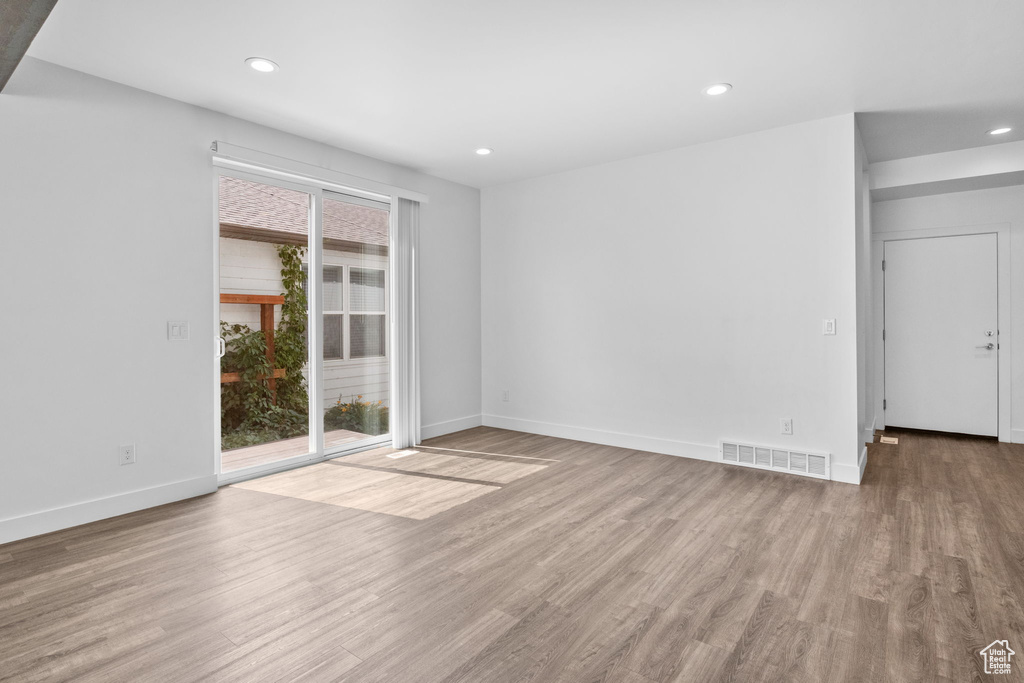 Spare room featuring wood finished floors and recessed lighting