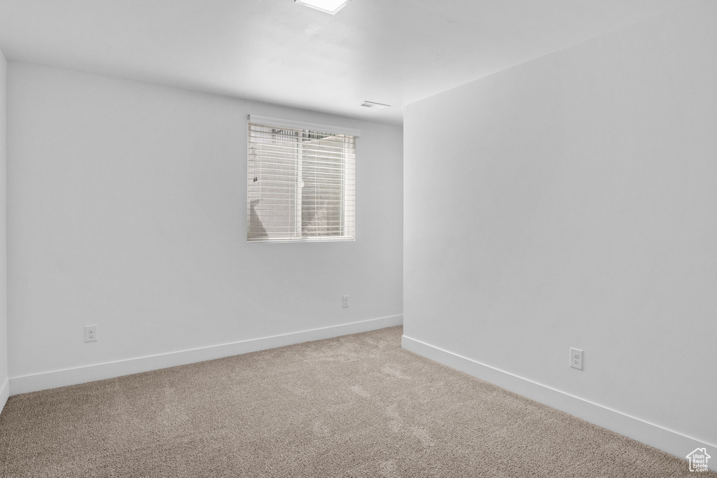 Unfurnished room with baseboards and carpet floors