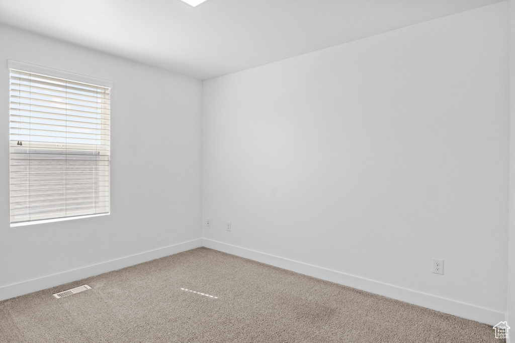 Spare room with carpet floors and baseboards
