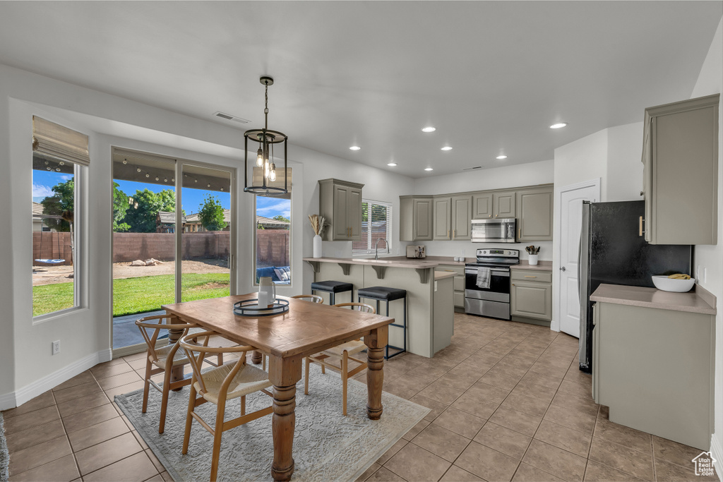 Dining room featuring light tile patterned flooring and recessed lighting