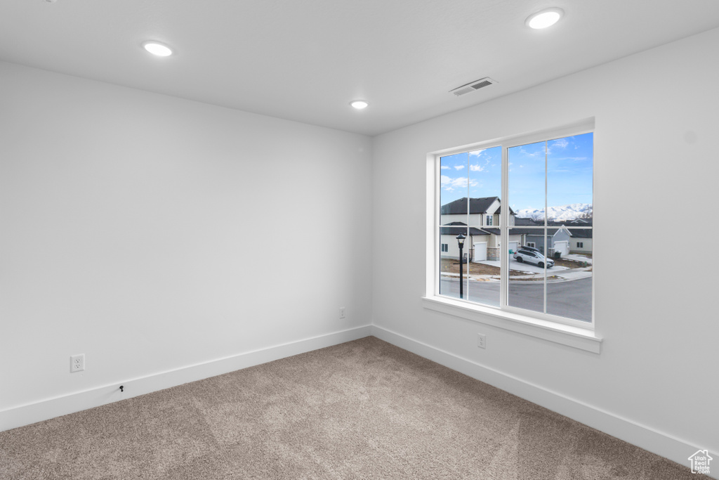 Empty room featuring carpet and recessed lighting