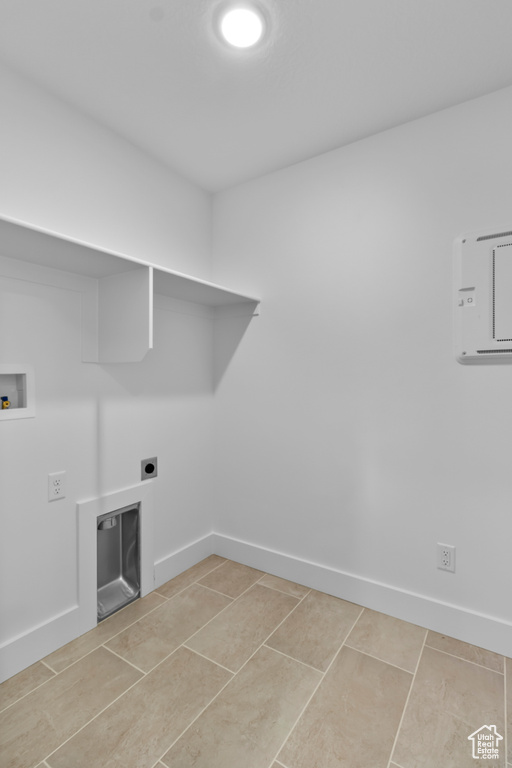 Washroom featuring washer hookup, electric dryer hookup, and light tile patterned floors