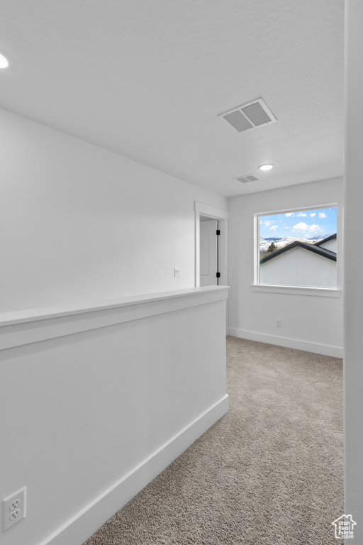 Hallway with carpet flooring and recessed lighting