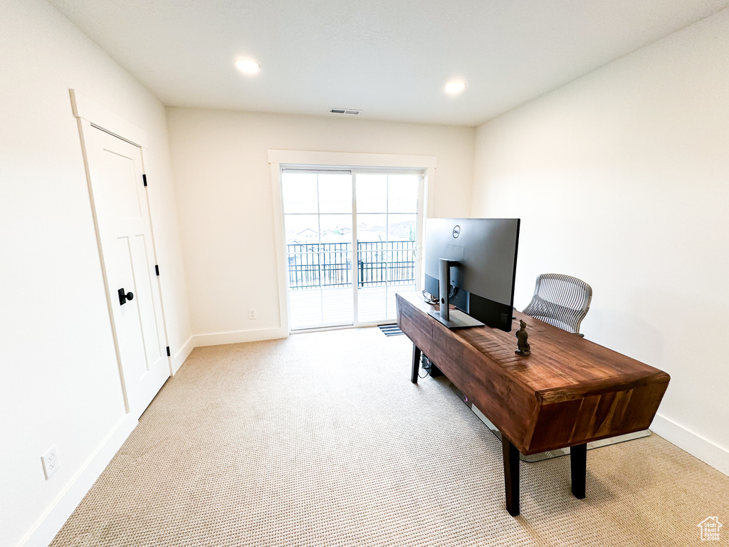 Office featuring light colored carpet and recessed lighting