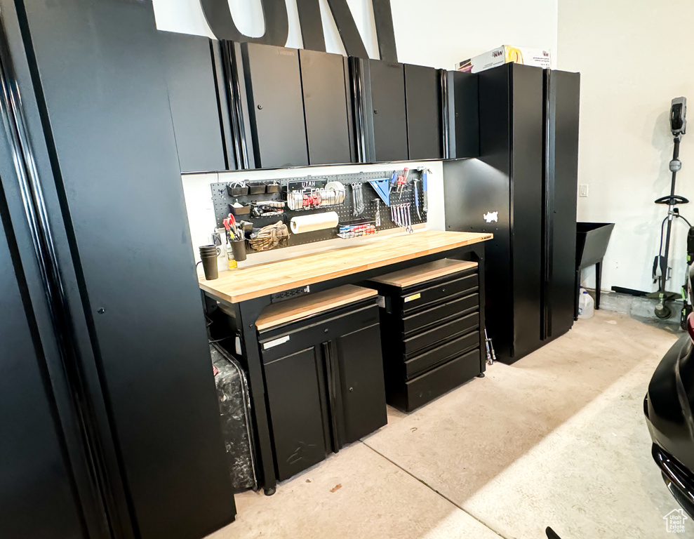 Kitchen with dark cabinets and wood counters