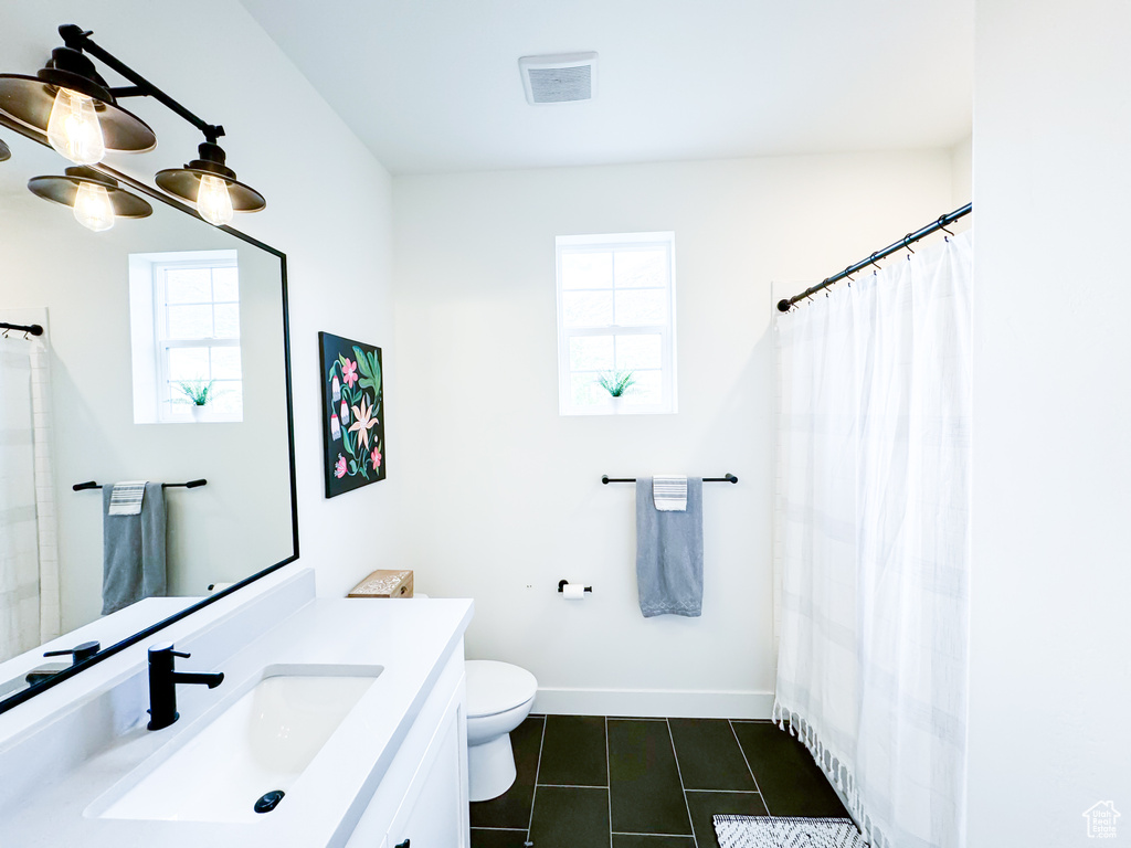 Full bathroom featuring vanity, tile patterned floors, and a shower with curtain