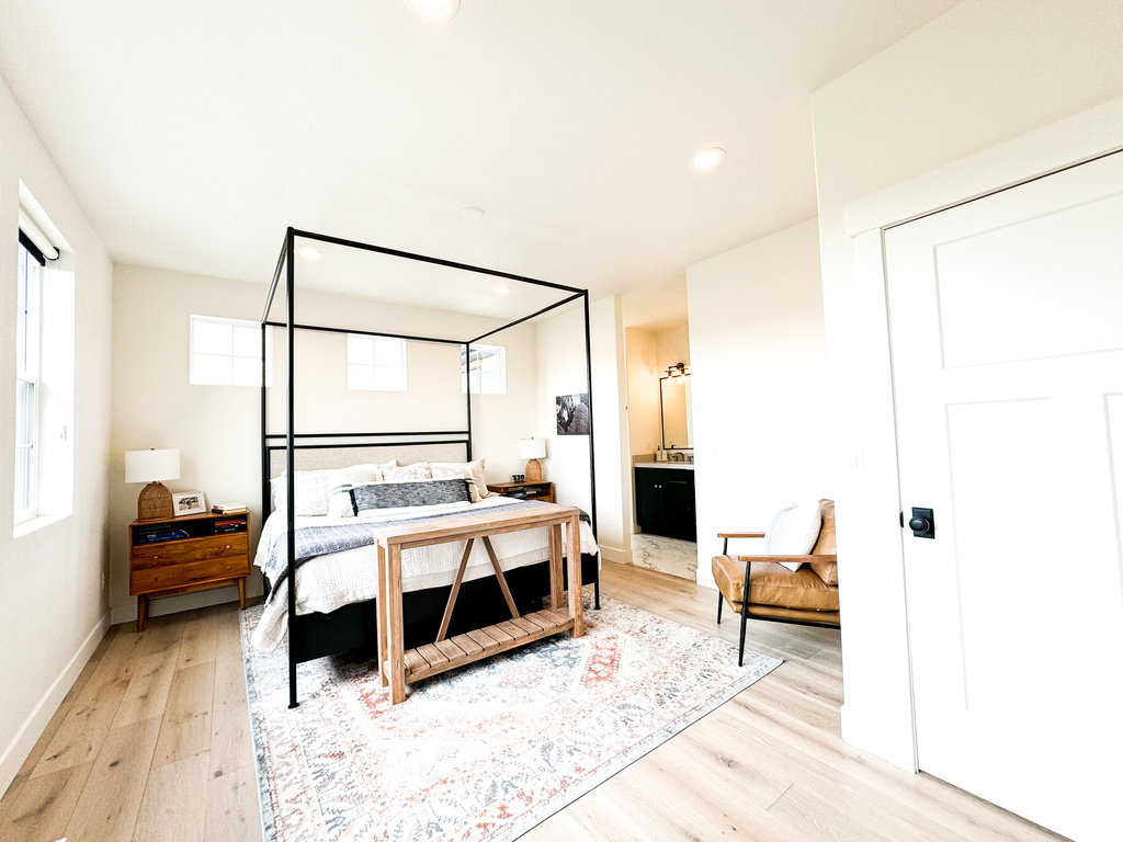 Bedroom with light wood-style floors, recessed lighting, and ensuite bathroom