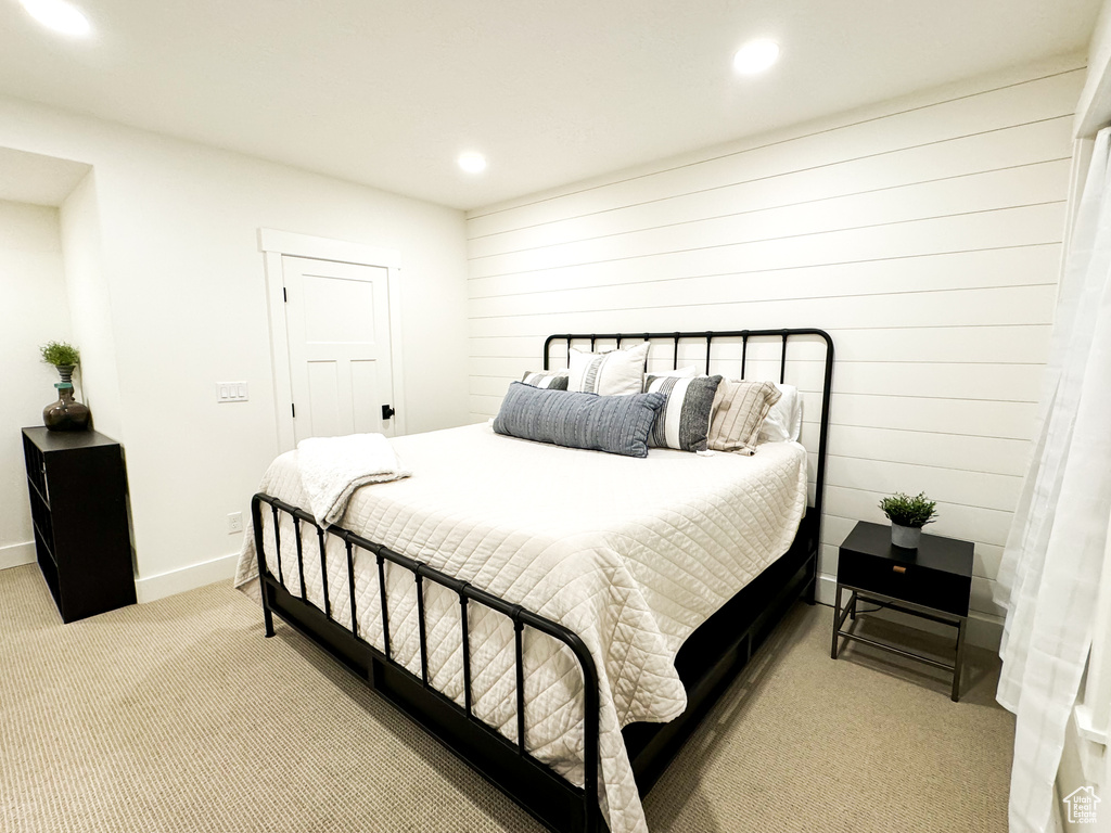 Bedroom with light carpet and recessed lighting
