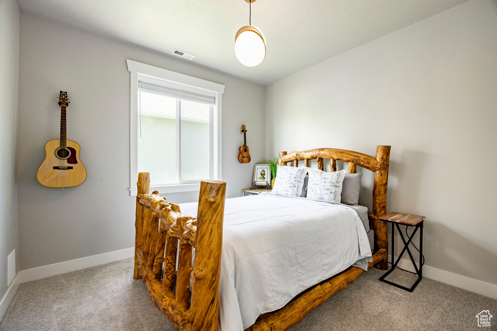 Bedroom featuring carpet floors and baseboards