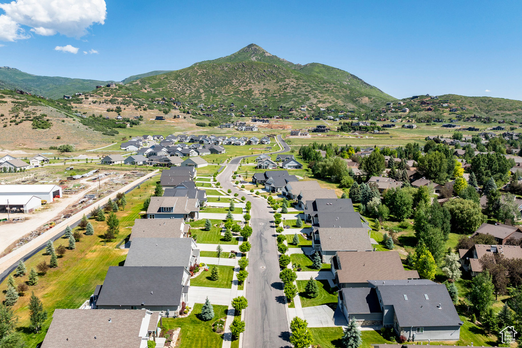 Aerial overview of property's location with nearby suburban area and a mountain backdrop