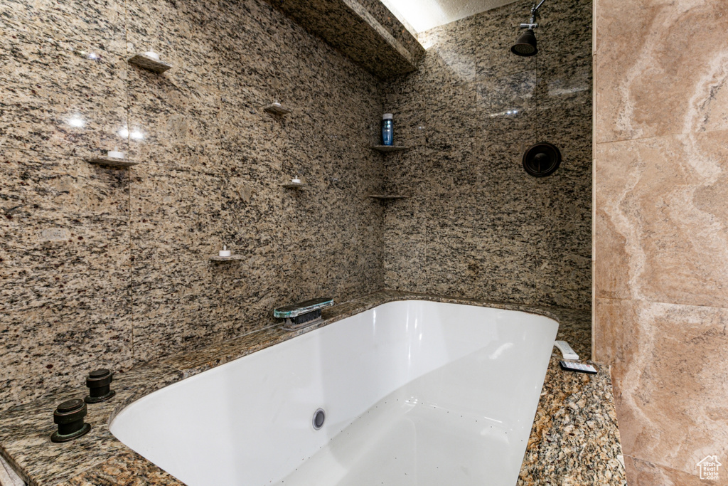 Full bath featuring a tub and a shower