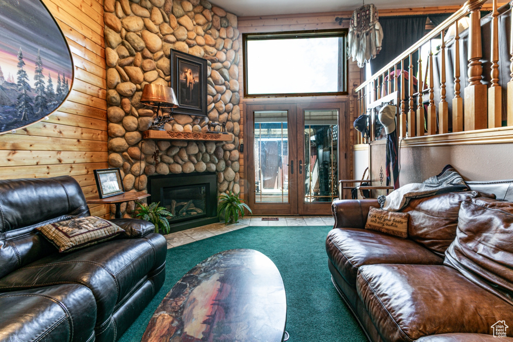 Living area with carpet floors, a fireplace, and french doors