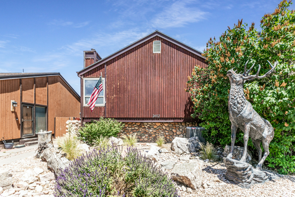 View of home\'s exterior featuring a chimney and stone siding