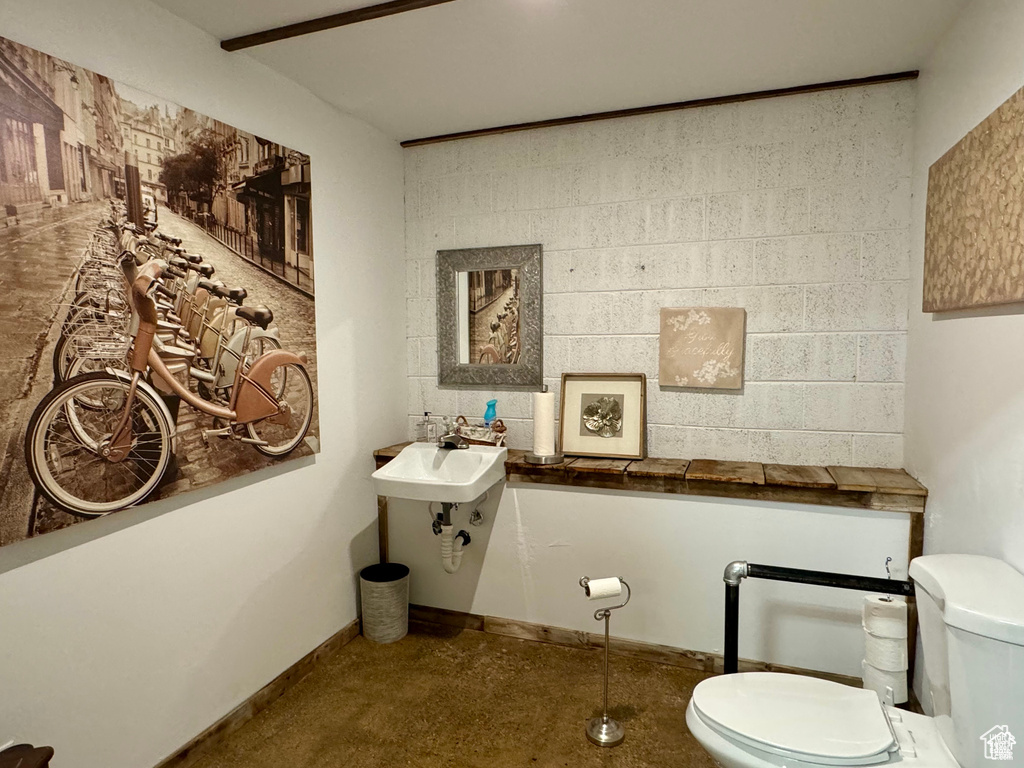 Half bath featuring toilet and a sink