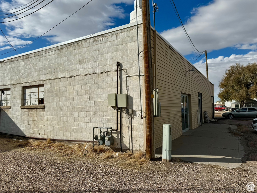 View of property exterior with concrete block siding