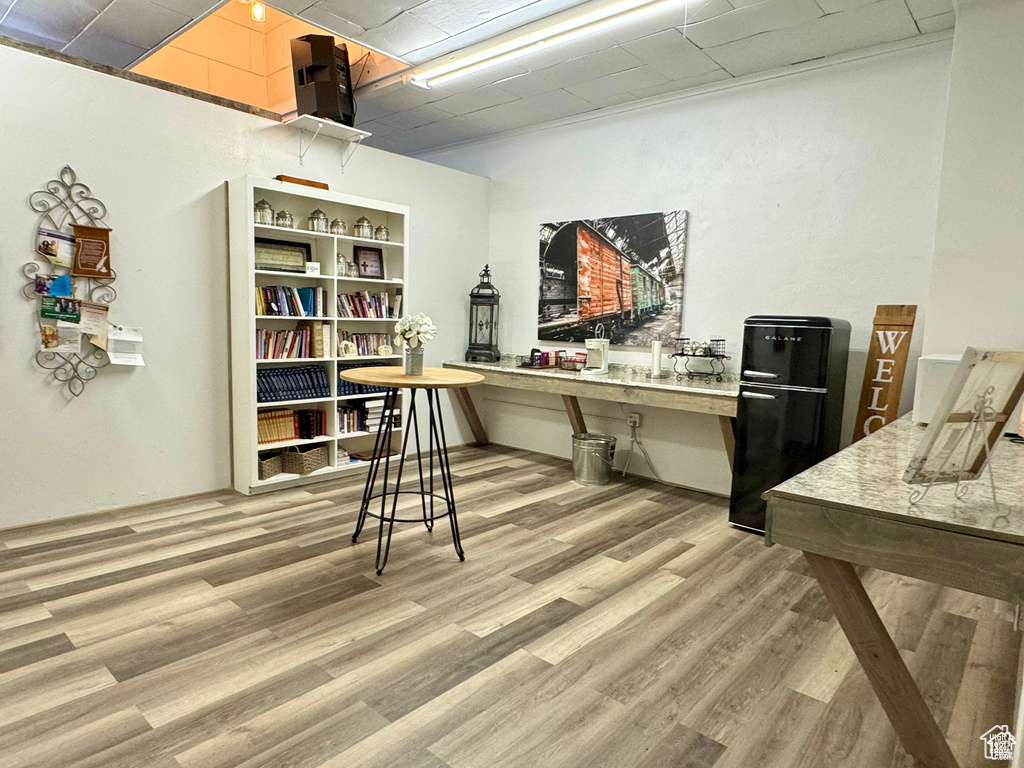 Home office with light wood-type flooring