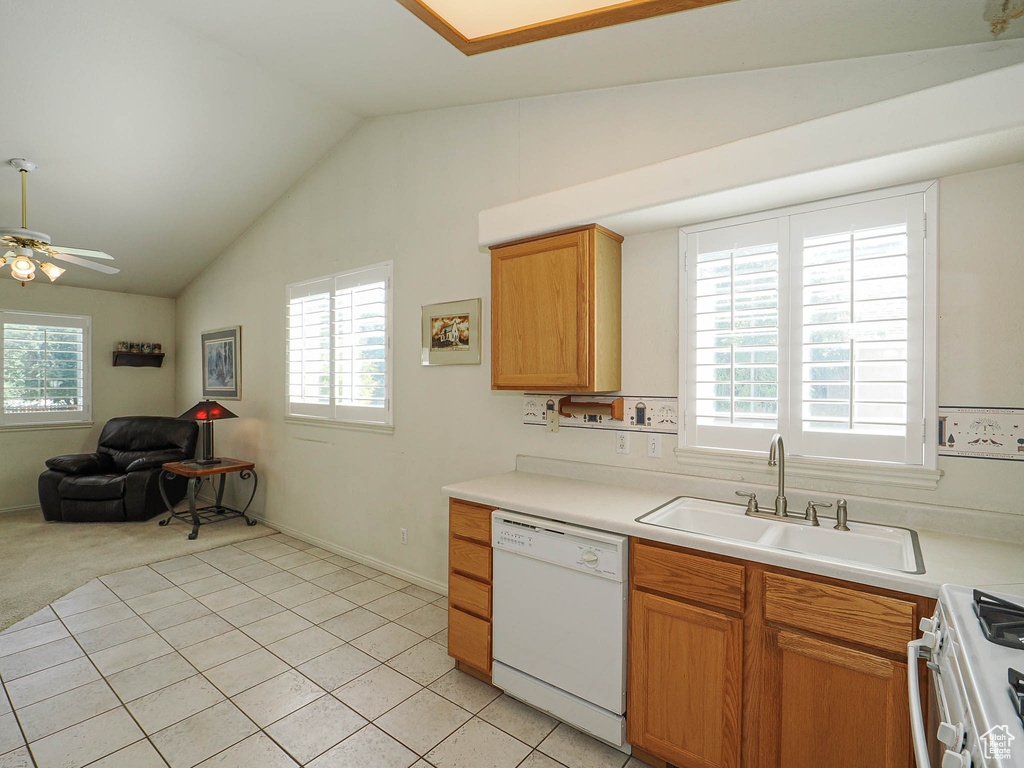 Kitchen with white appliances, lofted ceiling, plenty of natural light, open floor plan, and a ceiling fan