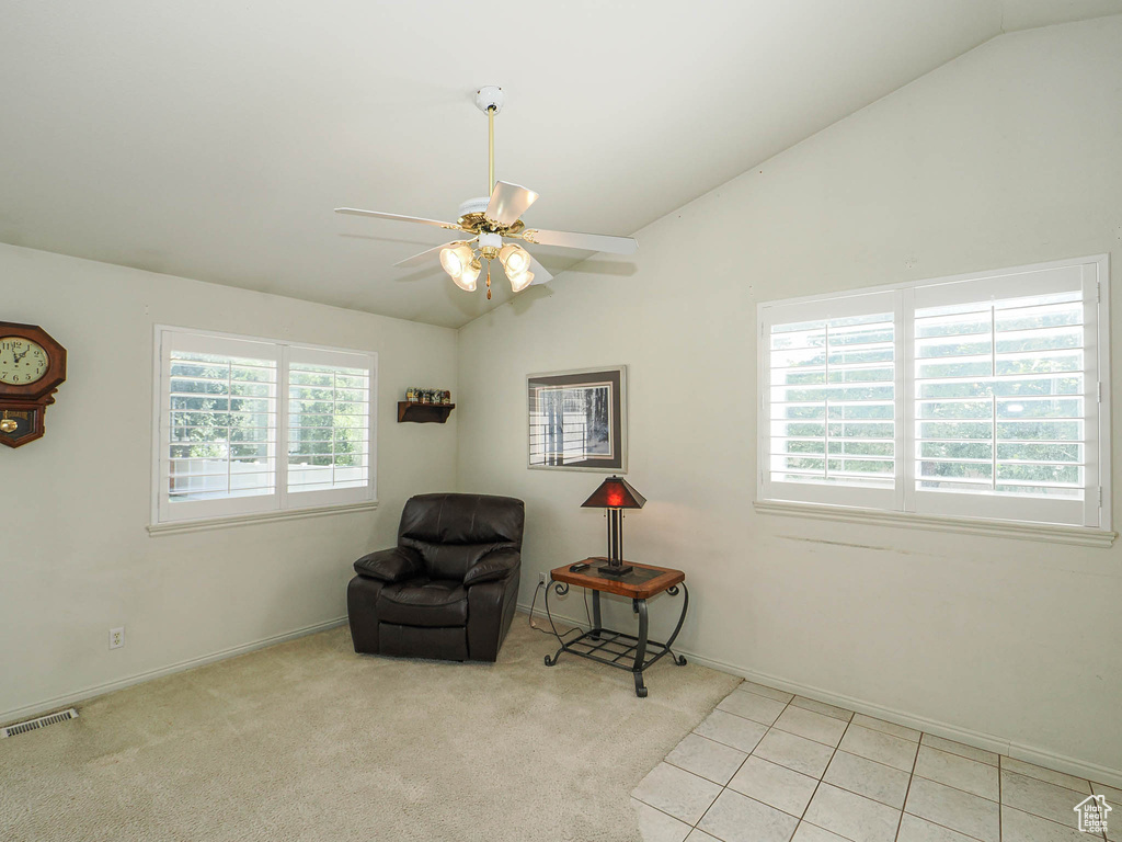 Sitting room featuring lofted ceiling and a ceiling fan