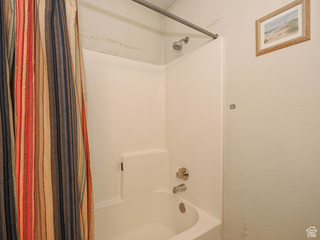 Bathroom featuring shower / bathtub combination with curtain