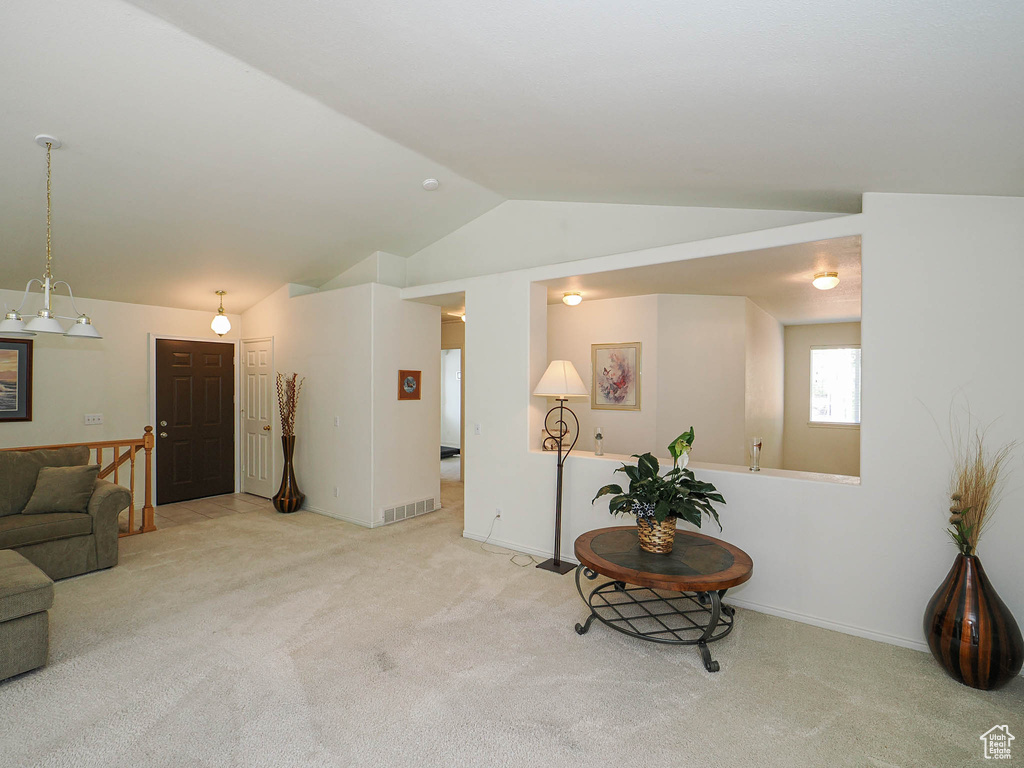 Living area featuring vaulted ceiling and carpet floors